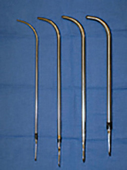 Four surgical instruments with curved ends.